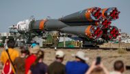 People watch as Soyuz MS-13 spacecraft for the new International Space Station (ISS) crew, comprising NASA astronaut Andrew Morgan, Luca Parmitano of ESA (European Space Agency) and Alexander Skvortsov of the Russian space agency Roscosmos, is transported
