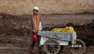 A boy pushes a cart as he is selling mangoes along a street in Peshawar, Pakistan July 19, 2019. Reuters/Fayaz Aziz