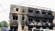 Japanese police officers inspect the scene where over 30 people died in a fire at the Kyoto Animation studio building in Kyoto on July 19, 2019. AFP / Jiji Press