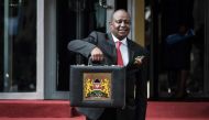 In this file photo taken on June 14, 2018 Kenya's Cabinet Secretary for National Treasury Henry Rotich poses with the budget briefcase before leaving for Parliament to read the budget speech for 2018-2019 in Nairobi, Kenya.