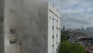 Smoke is seen after a fire broke out in a building in Mumbai on July 22, 2019. / AFP / PUNIT PARANJPE 