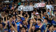 Fans hold an anti-extradition bill banner during a friendly match between Manchester City Football Club and Kitchee, in Hong Kong, China July 24, 2019. (REUTERS/Tyrone Siu)
