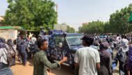 Sudanese protesters march past a security forces' vehicle during a demonstration commemorating protesters killed in past clashes, in the centre of the capital Khartoum on July 23, 2019. / AFP / Haitham EL-TABEI