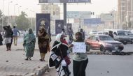 Sudanese protesters carry a placard during a rally in the capital Khartoum to condemn the 