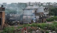 Military personnel work at the scene where a Pakistani Army Aviation Corps aircraft crashed in Rawalpindi on July 30, 2019. (AFP / AAMIR QURESHI)