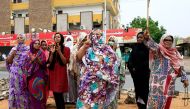 Sudanese demonstraters celebrate in Khartoum early on August 3, 2019, after Sudan's ruling generals and protest leaders reached a 