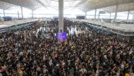 Anti-extradition bill protesters rally at the departure hall of Hong Kong airport in Hong Kong, China August 12, 2019. REUTERS/Thomas Peter