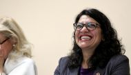 FILE PHOTO: U.S. Rep. Rashida Tlaib (D-MI) listens as Jim Pedersen of the A. Philip Randolph Institute speaks to the crowd during a town hall meeting featuring leadership from various voting rights organizations in Dearborn Heights, Michigan, U.S. July 20