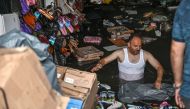 A shop owner tries to save his belongings in a flooded undergate shop center on August 17, 2019 in Eminonu district in Istanbul, after a heavy rainfall.   AFP / Ozan KOSE