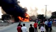 People look towards a fire following a fuel truck collision in Rubirizi, Uganda August 18, 2019 in this still image taken from social media video. 