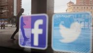 Facebook and Twitter logos are seen on a shop window in Malaga, Spain, June 4, 2018. REUTERS/Jon Nazca/File Photo