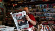 A kiosk owner reads a newspaper with news of Government crisis and the resignation of the prime minister Giuseppe Conte, in Rome, Italy, August 21, 2019. Reuters/Yara Nardi