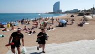 People leave Sant Sebastia beach after police found an explosive device in the water and evacuated part of it, possibly from the Spanish Civil War, in Barcelona, Spain August 25, 2019. REUTERS/Albert Gea	