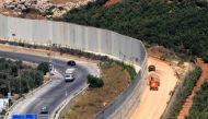 A view of the barrier along the border between Lebanon and Israel, with the Lebanese village of Kfar Kila on the left and the Israeli town of Metula on the right on August 29, 2019. AFP / Mahmoud Zayyat 