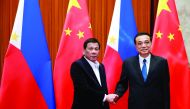 Philippine President Rodrigo Duterte (L) and Chinese Premier Li Keqiang shake hands during their meeting at the Great Hall of the People in Beijing, China, August 30, 2019. How Hwee Young/Pool via Reuters