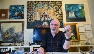 Turkey's micro artist Hasan Kale gestures as he speaks during an interview in Istanbul on August 23, 2019. AFP / Ozan Kose 
