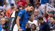 Novak Djokovic of Serbia leaves the court as he concedes the match to Stan Wawrinka of Switzerland during their Round Four Men's Singles match at the 2019 US Open at the USTA Billie Jean King National Tennis Center in New York on September 1, 2019. AFP / 