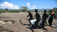 Rescue team carry bodies of 7 tourists retrieved at Suswa area of Nakuru County on September 2, 2019 after they were swept by flash floods the day before inside while hiking a gorge at Hells Gate National Park in Naivasha, Nakuru. / AFP / Suleiman MBATIAH