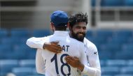 Virat Kohli (L) and Ravindra Jadeja (R) of India hug in celebration of Jahmar Hamilton of West Indies dismissal during day 4 of the 2nd Test between West Indies and India at Sabina Park, Kingston, Jamaica, on September 2, 2019. AFP / Randy Brooks

