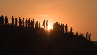 In this file photo taken on November 26, 2017, Rohingya Muslim refugees walk down a hillside in the Kutupalong refugee camp in Bangladesh. AFP / Ed Jones