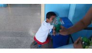 A boy looks on as his mother holds the nebuliser that is helping him with symptons of smoke inhalation, in Porto Velho, Brazil, on August 31, 2019. Thomson Reuters Foundation/Fabio Teixeira