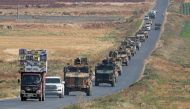 A convoy of Turkish military vehicles passing through the village of Kafr Halab on the western edge of Aleppo province. / AFP / Omar HAJ KADOUR