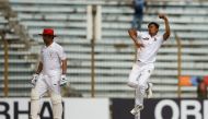 Bangladeshi cricketer Taijul Islam (R) delivers a ball during the first day of the one-off cricket Test match between Bangladesh and Afghanistan at the Zohur Ahmed Chowdhury Stadium in Chittagong on September 5, 2019. / AFP / STR
