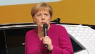 German Chancellor Angela Merkel speaks next to an ID.3 electric car as she visits the booth of German car giant Volkswagen (VW) during her opening tour at the IAA Car Show in Frankfurt on September 12, 2019. AFP / Daniel ROLAND