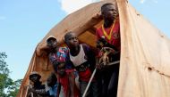 Central African refugees coming back after years in Congo-Brazzaville stand at the rear of a truck in Mongoumba, at the Congo-Brazzaville border, about 100 km south of Bangui on September 2, 2019. AFP / Camille Laffont 