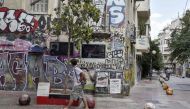 A man walks past a memorial at a spot where a 15-years old student was killed by police in 2008, sparking unrest in greece, in Athens' historic district of Exarchia on September 13, 2019. AFP / LOUISA GOULIAMAKI