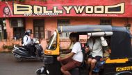 Commuters go past a hostel named 'Bollywood' in Mumbai on September 16, 2019. AFP / Indranil Mukherjee