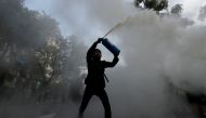 An anti-government protester uses a fire extinguisher during a march in Tuen Mun, Hong Kong, China September 21, 2019. REUTERS/Tyrone Siu