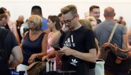Tourists queue up in a check-in service at Cancun International Airport after Thomas Cook, the world's oldest travel firm, collapsed stranding hundreds of thousands of holidaymakers around the globe and sparking the largest peacetime repatriation effort i