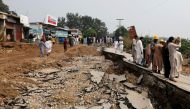 Residents walk along a road damaged during an earthquake in Jatlan, Mirpur, Pakistan September 25, 2019. REUTERS/Akhtar Soomro