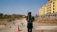 A Chinese police officer takes his position by the road near a vocational education centre in Yining in Xinjiang Uighur Autonomous Region, China, September 4, 2018. Reuters / Thomas Peter