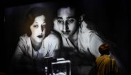 A woman walks past an image of Indian Prince, Yeshwant Rao Holkar II and his wife Sanyogita Devi of Indore, as she visits the opening of 