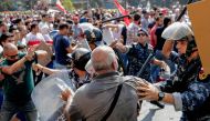 Lebanese protesters clash with riot policemen as they try to break through security barriers in front of the cabinet office during a demonstration in central Beirut's Martyr Square on September 29, 2019. AFP / ANWAR AMRO