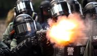 A riot police fires tear gas to disperse anti-government protesters after a march in Hong Kong, China, September 29, 2019. Reuters/Athit Perawongmetha