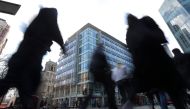 Pedestrians pass the shared building which houses the offices of Cambridge Analytica in central London on March 21, 2018. AFP/Daniel Leal-Olivas