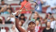 Naomi Osaka of Japan waves to the crowd after winning her women's singles third round match against Alison Riske of the US at the China Open tennis tournament in Beijing on October 3, 2019. / AFP / GREG BAKER 
