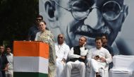 Congress Party president Sonia Gandhi speaks at an event to mark the 150th birth anniversary of Mahatma Gandhi, as her son Rahul Gandhi (R) looks at his phone behind her, in New Delhi on October 2, 2019.  AFP / Money Sharma
 