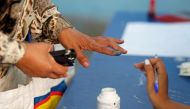 A woman has her finger stained with ink at a polling station during parliamentary elections, in Tunis, Tunisia October 6, 2019. REUTERS/Zoubeir Souissi
 