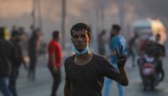 File photo of An Iraqi demonstrator gestures with the v-sign for victory during a demonstration against state corruption, failing public services, and unemployment, in the Iraqi capital Baghdad on October 5, 2019. / AFP / AHMAD AL-RUBAYE 