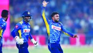Sri Lanka's spinner Wanindu Hasaranga (R) celebrates with teammates after dismissal of Pakistan's captain Sarfraz Ahmed during the second Twenty20 International cricket match between Pakistan and Sri Lanka at the Gaddafi Cricket Stadium in Lahore on Octob