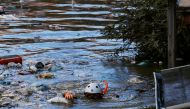 A rescue worker swims as he checks around a flooded residential area due to Typhoon Hagibis, in Kawasaki, Japan, October 13, 2019. REUTERS/Kim Kyung-Hoon 
