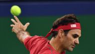 Roger Federer of Switzerland hits a return against Alexander Zverev of Germany during their men's singles quarter-final match at the Shanghai Masters tennis tournament in Shanghai on October 11, 2019. / AFP / HECTOR RETAMAL