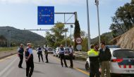 Spanish police officers and drivers stand on the motorway in Le Perthus near the Franco-Spanish border as Catalan demonstrators block the Spanish motorway during Catalonia's general strike, France, October 19, 2019, 2019. REUTERS/Regis Duvignau