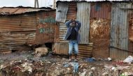 A child stands behind pit latrines made of rusted iron sheets in Kibera slum within Nairobi, Kenya, February 24, 2019. Reuters / Njeri Mwangi