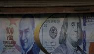 FILE PHOTO: Posters of U.S. dollar and Turkish lira are seen on a currency exchange shop in the city of Azaz, Syria August 18, 2018. Picture taken August 18, 2018. REUTERS/ Khalil Ashawi