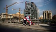 A demonstrator carries a Lebanese national flag during ongoing anti-government protests in downtown Beirut, Lebanon, October 28, 2019. REUTERS/Alkis Konstantinidis